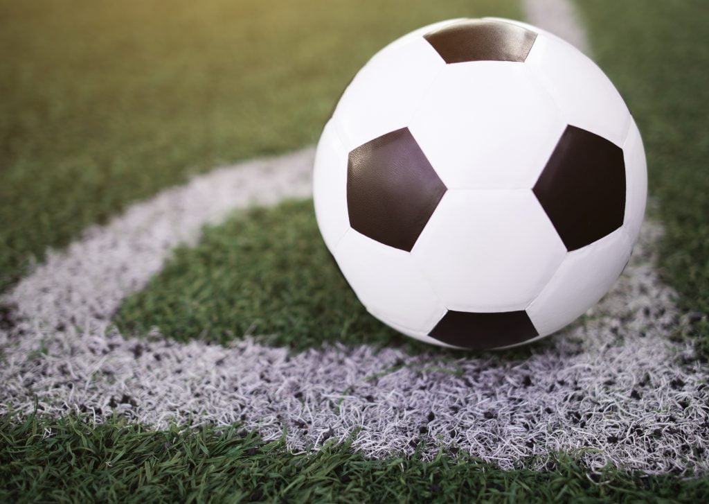 soccer ball on the white line at stadium